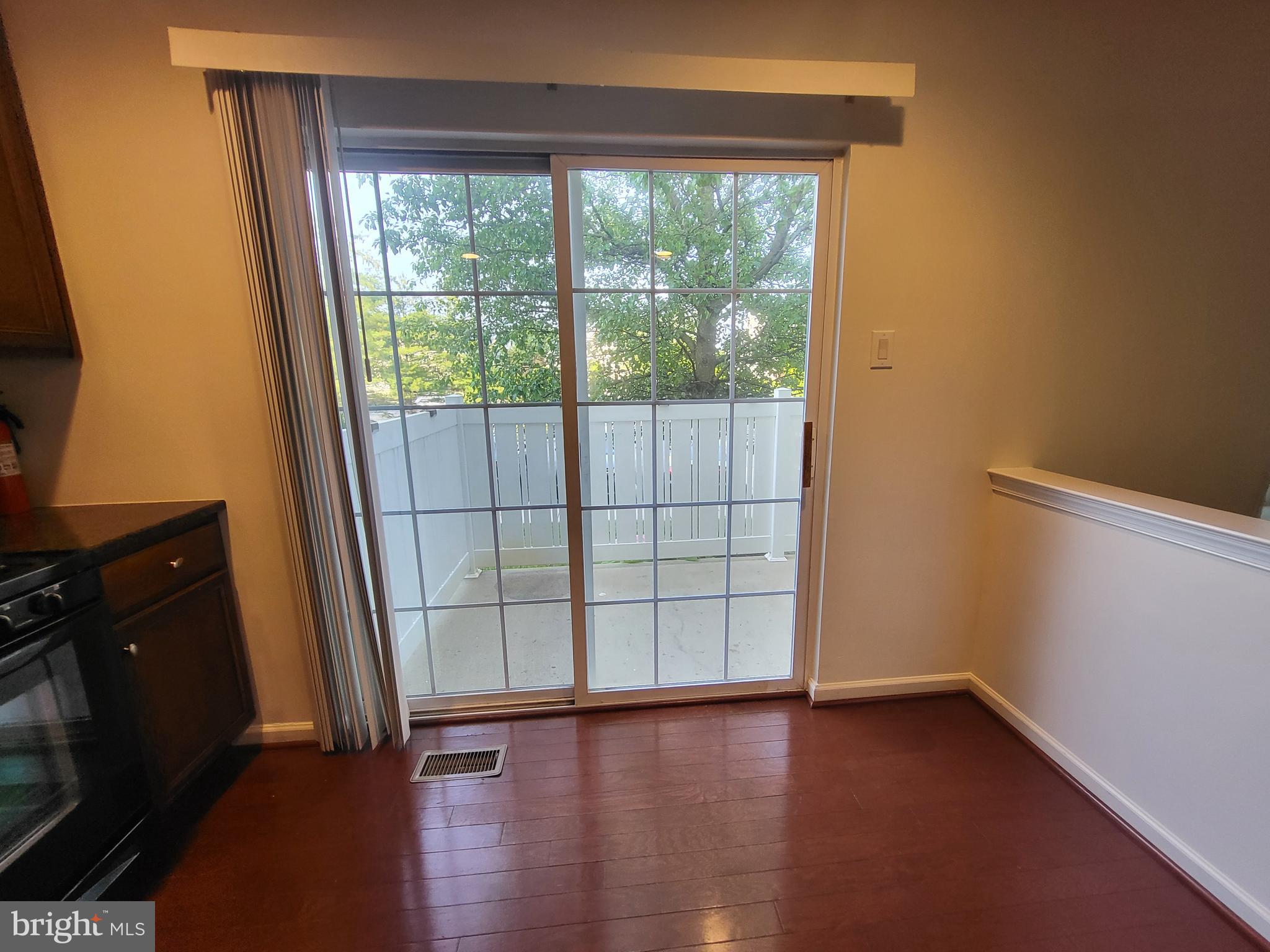 284 Flagstone Road, Unit 5 Chester Springs, PA 19425 - Photo 11 of 25 an empty room with wooden floor and windows with curtains