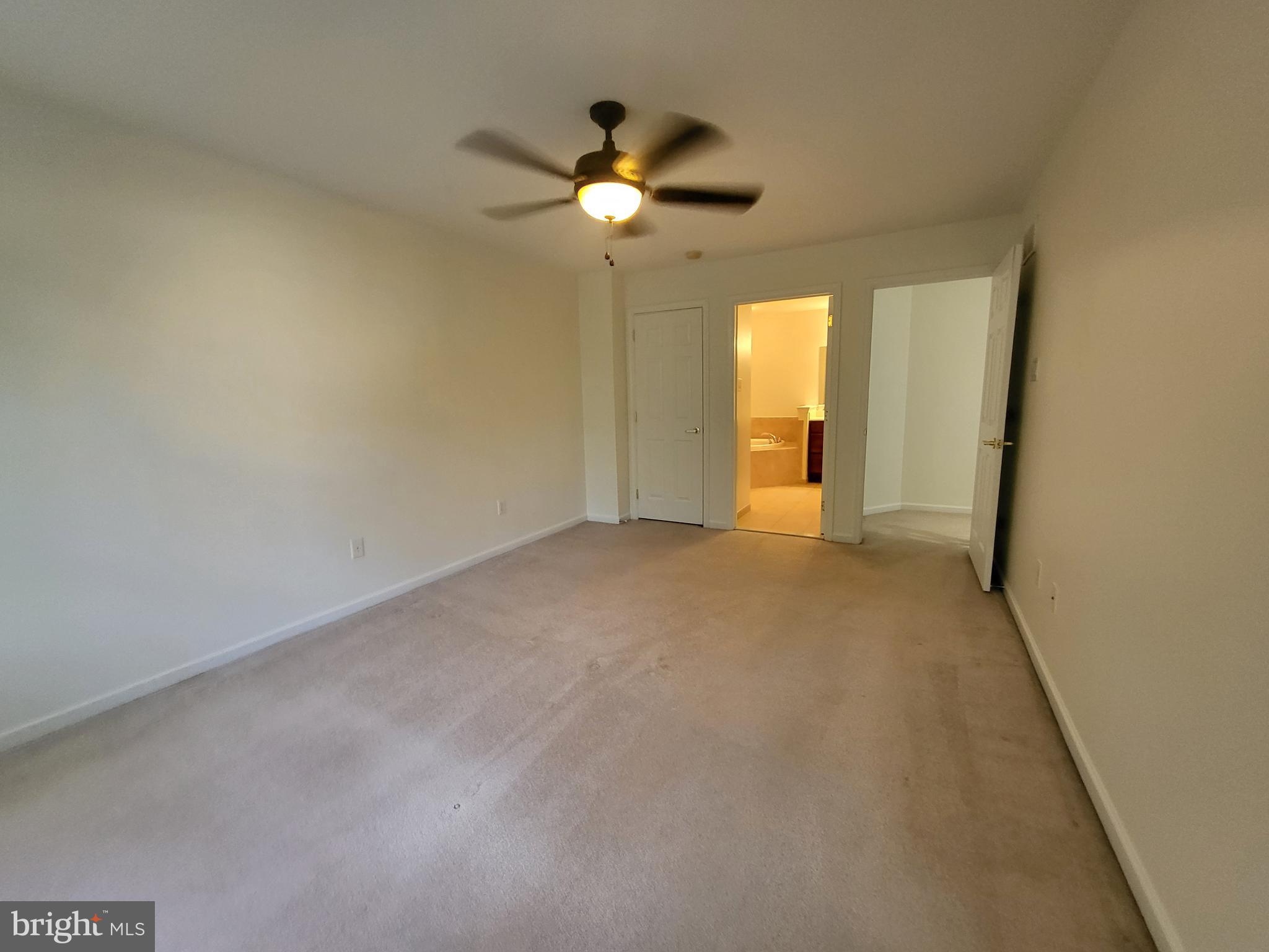 284 Flagstone Road, Unit 5 Chester Springs, PA 19425 - Photo 15 of 25 an empty room with a chandelier fan and windows