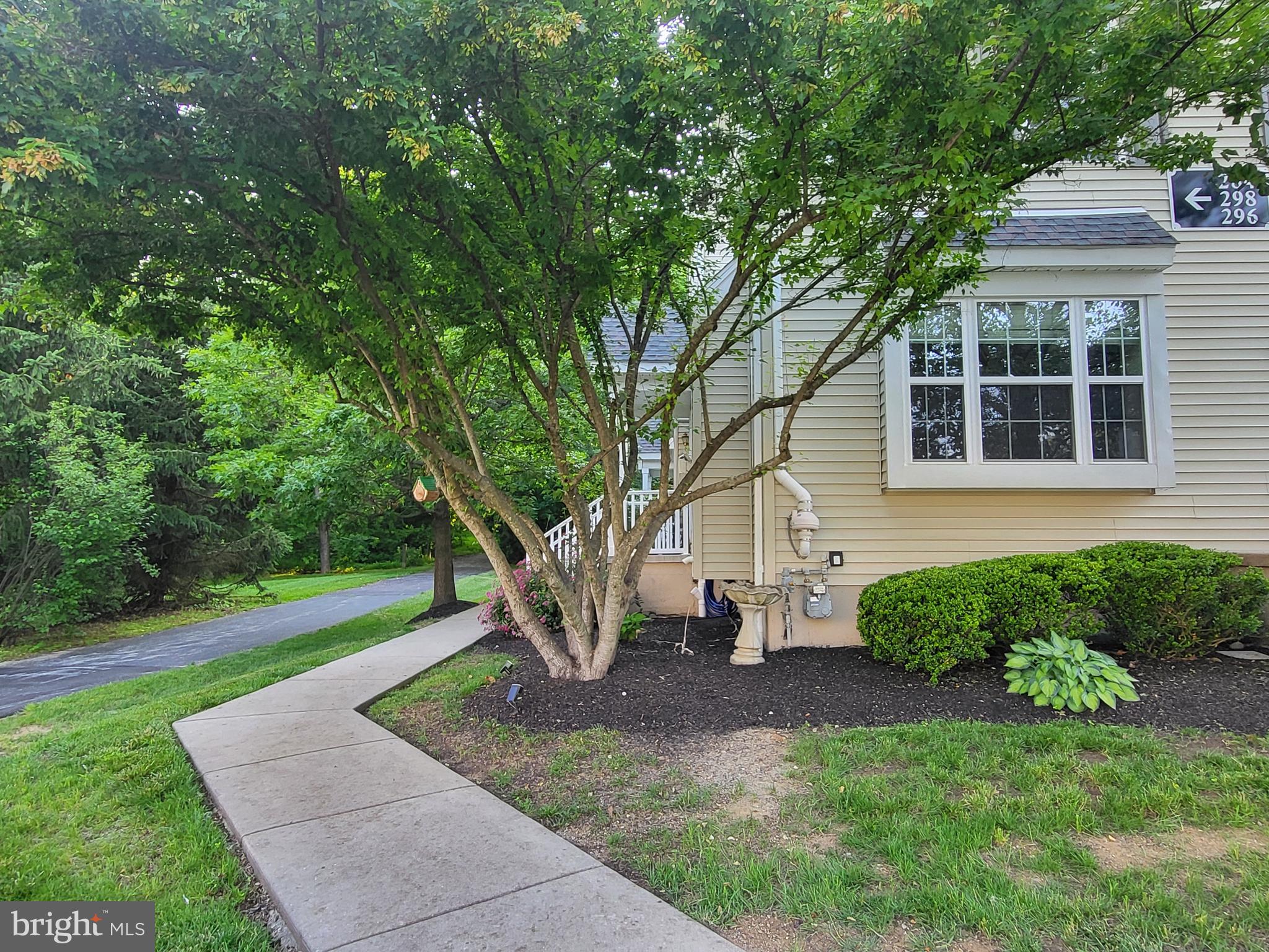 284 Flagstone Road, Unit 5 Chester Springs, PA 19425 - Photo 2 of 25 a front view of a house with garden