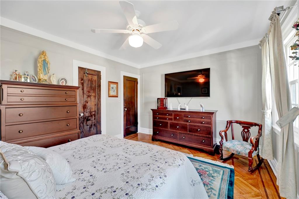 7607 Colonial Road Brooklyn, NY 11209 - Photo 17 of 35 a bedroom with a bed and a flat screen tv