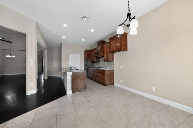 a kitchen with stainless steel appliances a refrigerator and a stove top oven