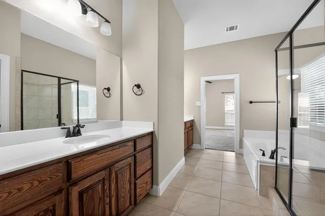 a spacious bathroom with a double vanity sink mirror and double