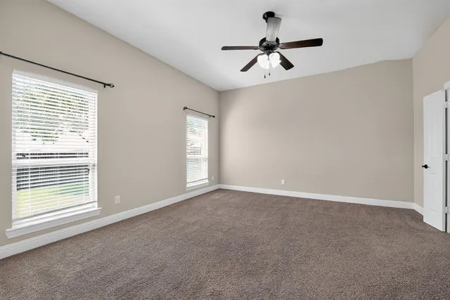 a view of room with a ceiling fan and window