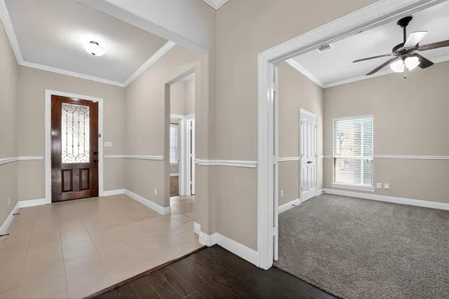 an empty room with a hallway and stairs