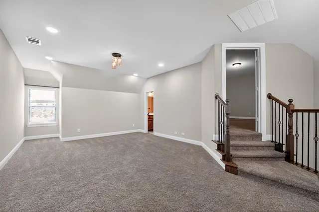 an empty room with closet and a ceiling fan