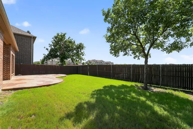 a view of a house with a yard and porch