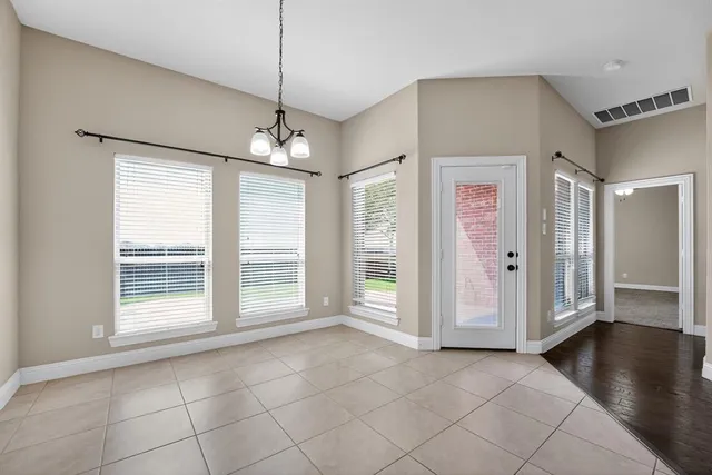 a view of a livingroom with an empty space and a window