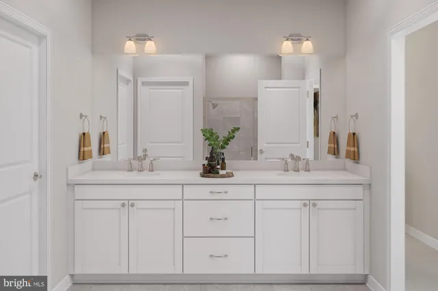 a bathroom with white cabinets sink and mirror