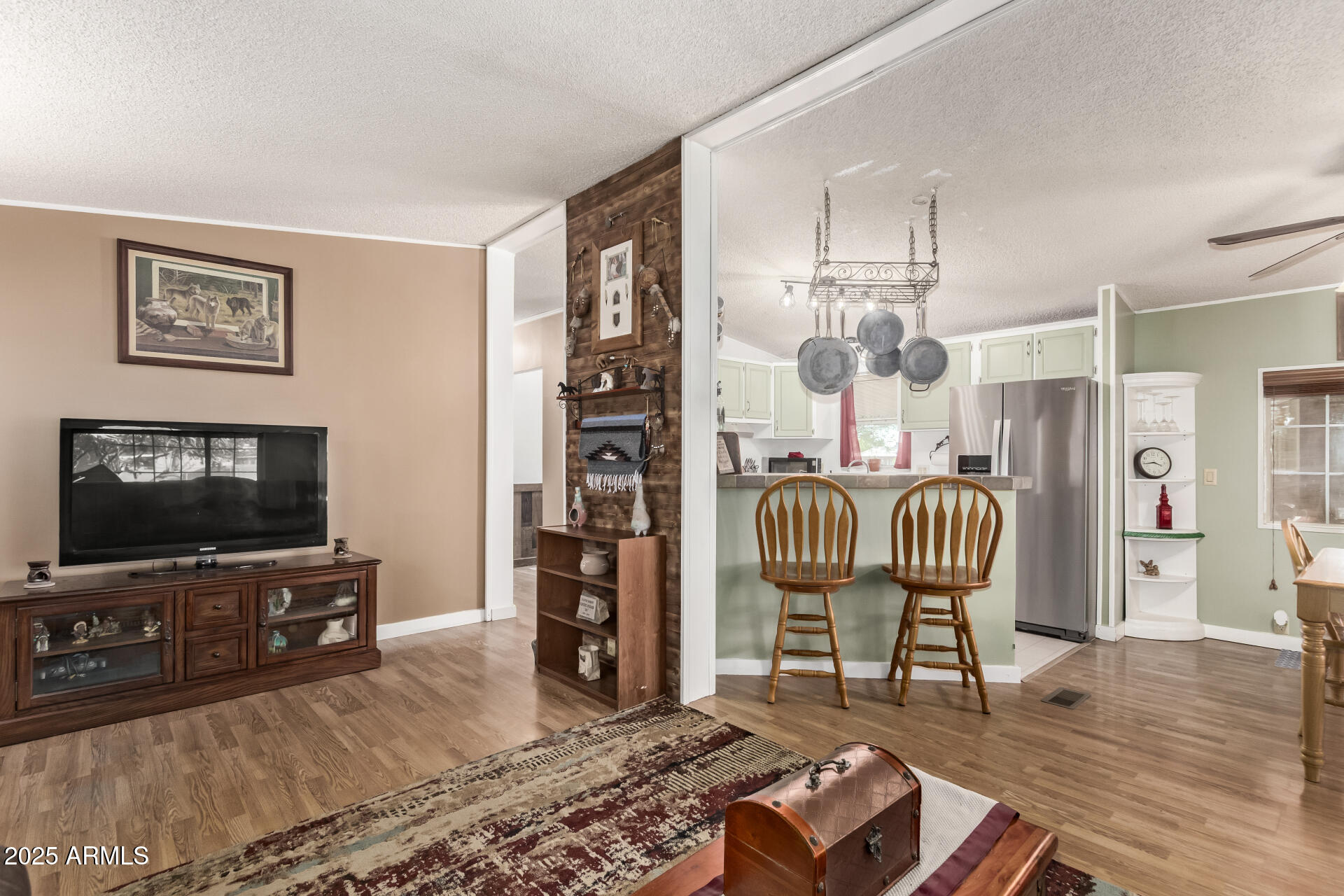 164 North Wickiup Road Apache Junction, AZ 85119 - Photo 13 of 62 a living room with furniture and a flat screen tv