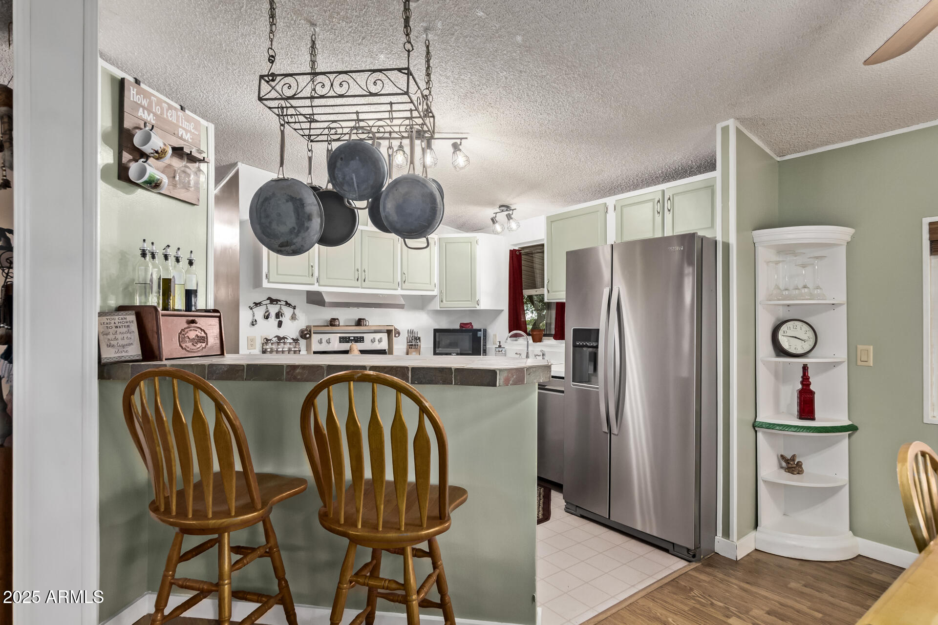 164 North Wickiup Road Apache Junction, AZ 85119 - Photo 16 of 62 a kitchen with stainless steel appliances granite countertop a table chairs and a refrigerator