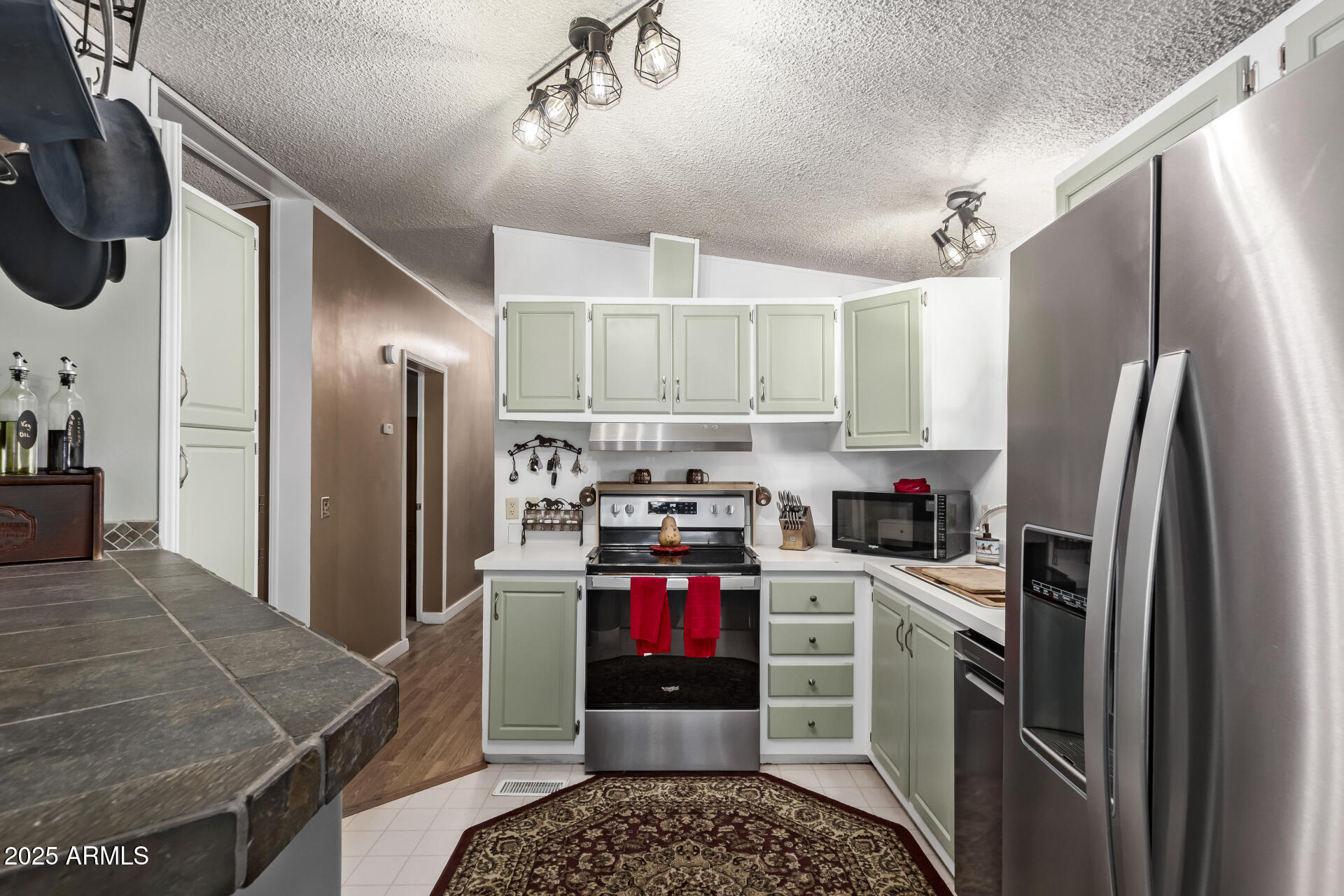 164 North Wickiup Road Apache Junction, AZ 85119 - Photo 17 of 62 a kitchen with stainless steel appliances granite countertop a refrigerator stove and sink