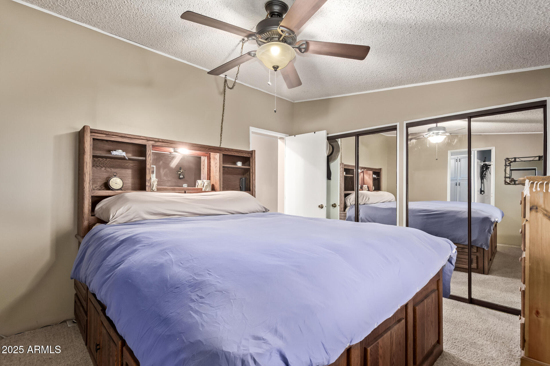 164 North Wickiup Road Apache Junction, AZ 85119 - Photo 21 of 62 a bedroom with a large bed and a chandelier