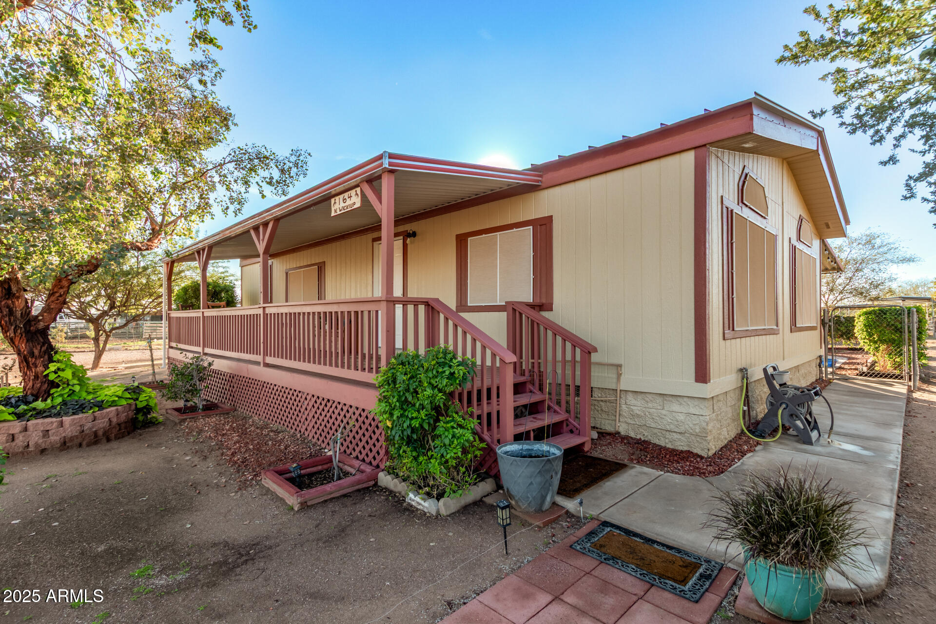 164 North Wickiup Road Apache Junction, AZ 85119 - Photo 8 of 62 a front view of a house with garden