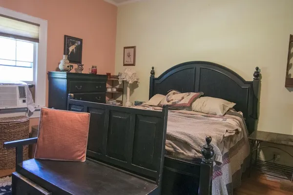 a bedroom with a bed and a dresser
