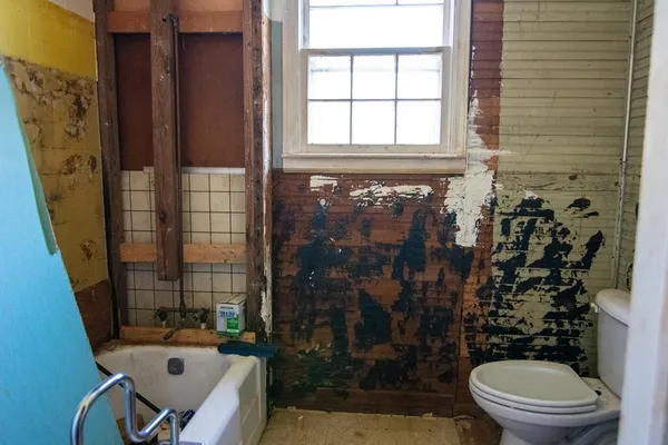 a bathroom with a sink toilet and a mirror