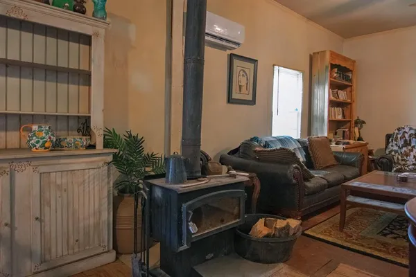 a living room with furniture fireplace and a window