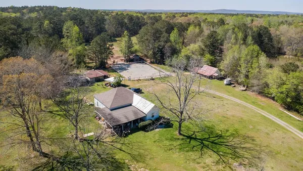 an aerial view of a house with a yard