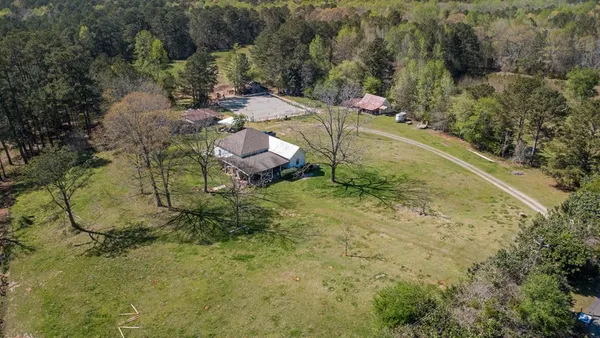 an aerial view of a house with a yard
