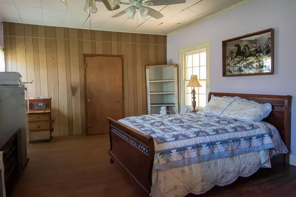 a bedroom with a bed and a dresser