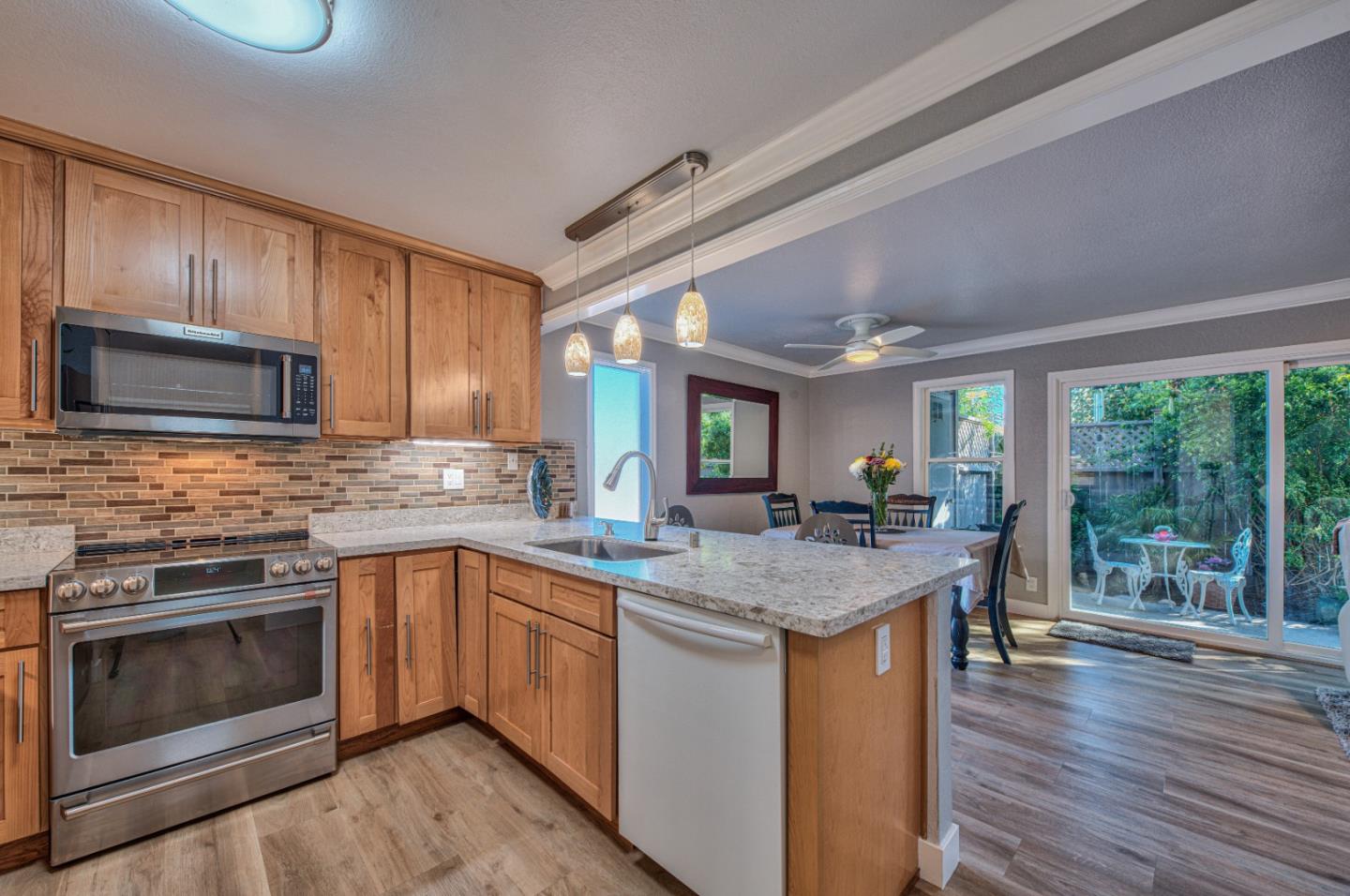 a kitchen with a stove sink and microwave