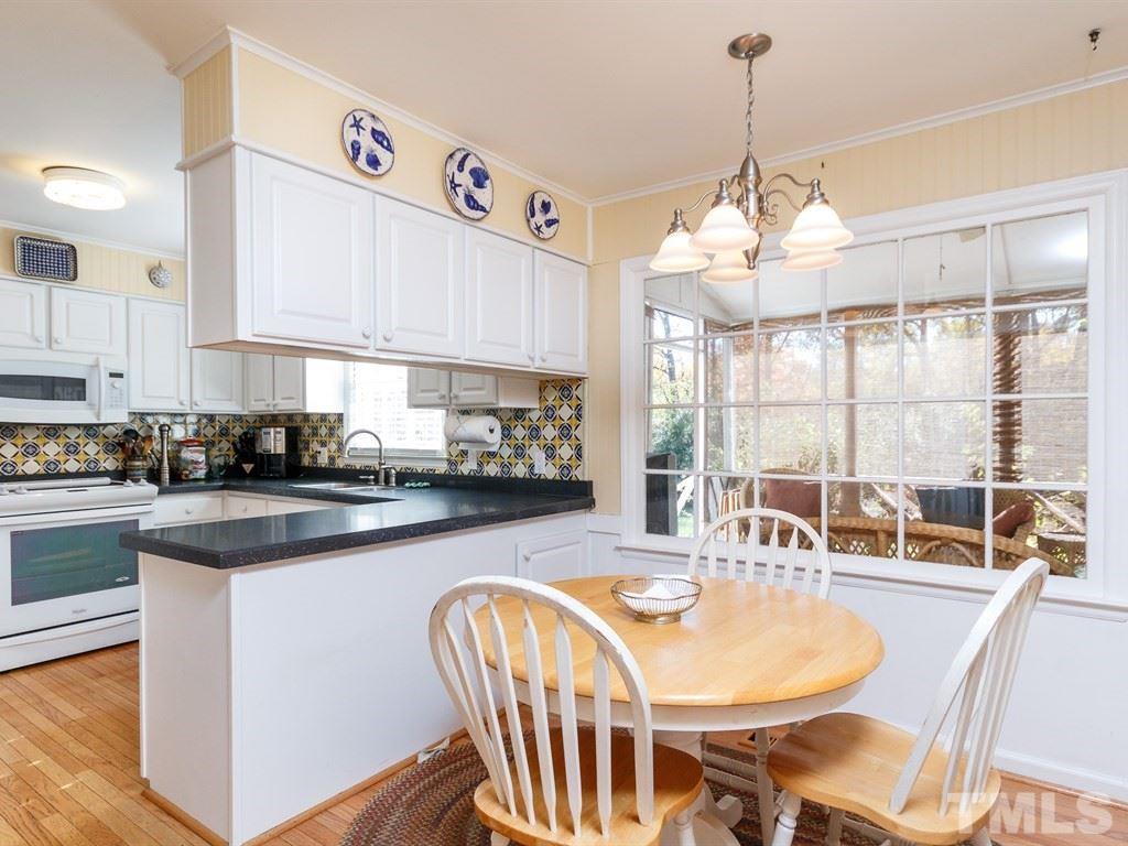5704 Setter Circle Raleigh, NC 27609 - Photo 11 of 25 a kitchen with kitchen island a large window cabinets a sink and appliances