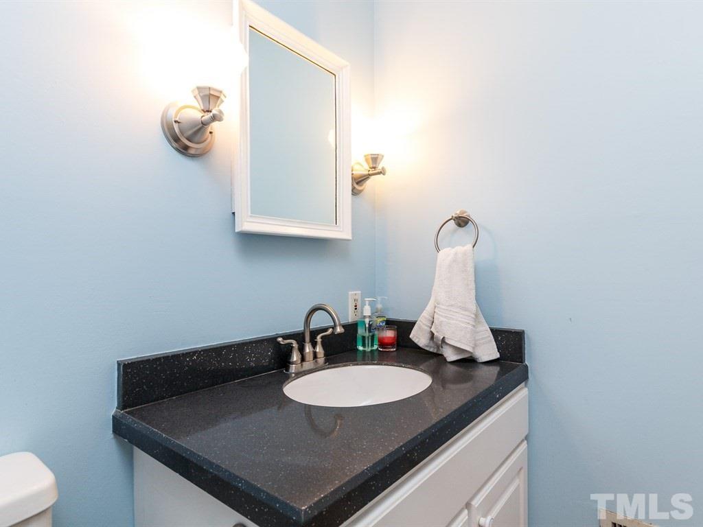 5704 Setter Circle Raleigh, NC 27609 - Photo 14 of 25 a bathroom with a sink and a mirror