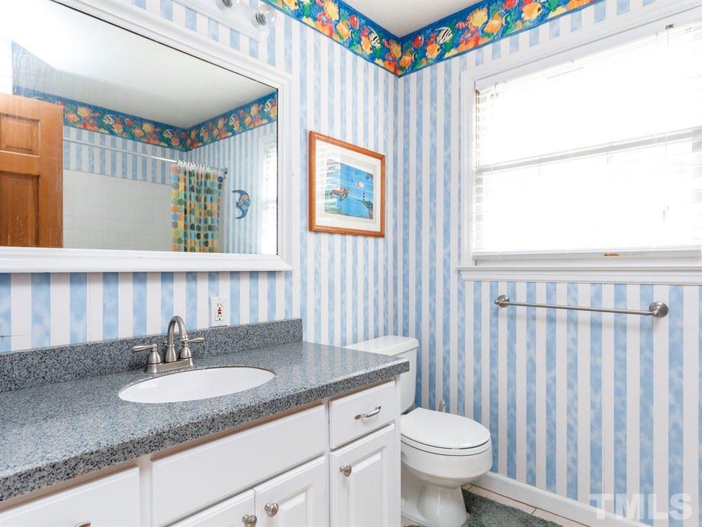 5704 Setter Circle Raleigh, NC 27609 - Photo 16 of 25 a bathroom with a granite countertop sink and a mirror