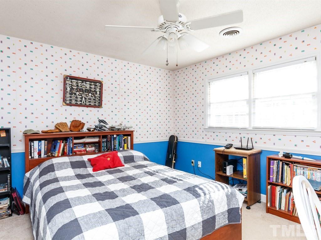 5704 Setter Circle Raleigh, NC 27609 - Photo 18 of 25 a bedroom with a bed and a table