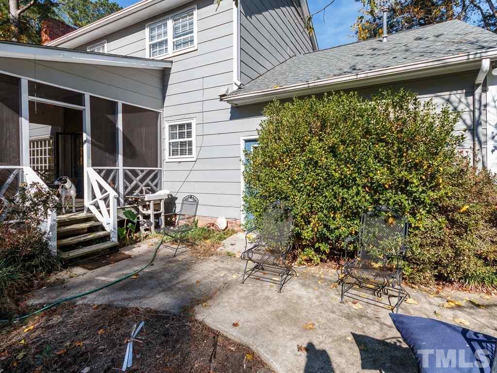 5704 Setter Circle Raleigh, NC 27609 - Photo 24 of 25 a view of a patio with table and chairs and wooden fence