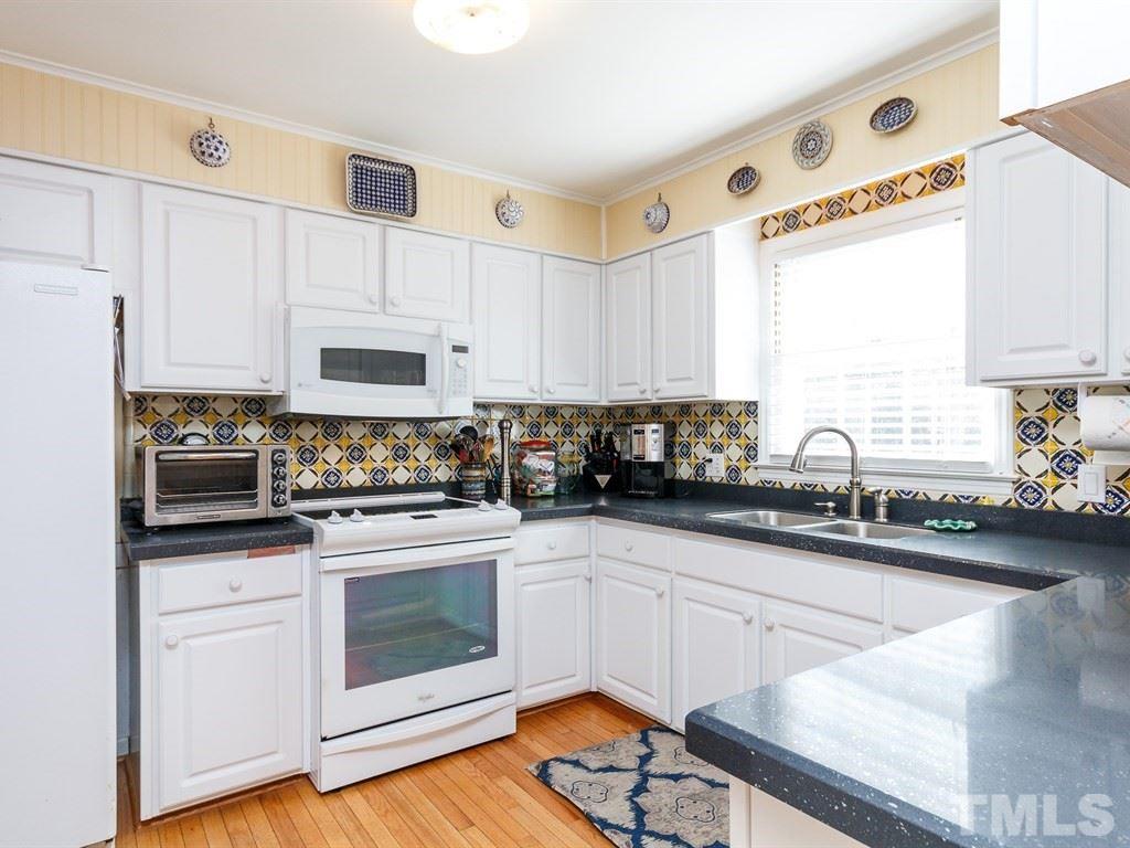 5704 Setter Circle Raleigh, NC 27609 - Photo 10 of 25 a kitchen with stainless steel appliances cabinets a sink and a stove