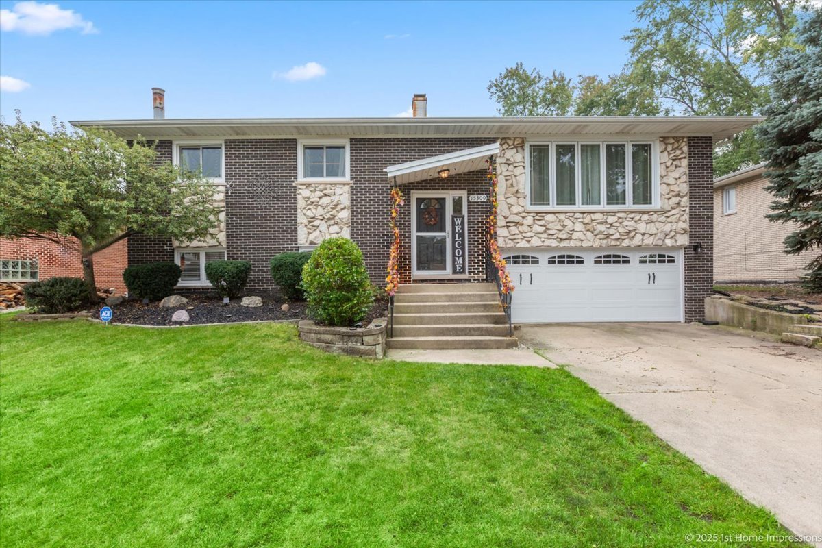 15309 Walnut Road Oak Forest, IL 60452 - Photo 1 of 23 a front view of a house with a garden and plants