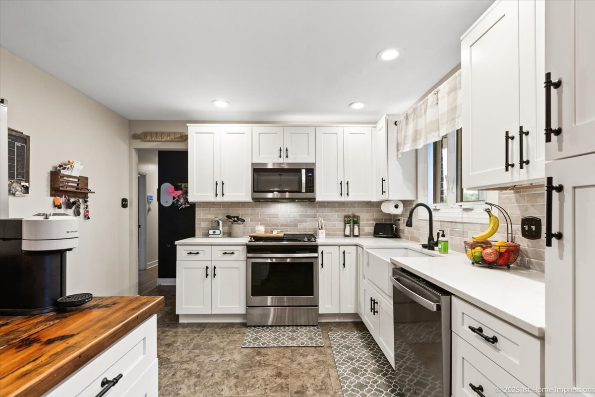 15309 Walnut Road Oak Forest, IL 60452 - Photo 13 of 23 a kitchen with stainless steel appliances granite countertop a refrigerator a stove top oven a sink dishwasher and white cabinets with wooden floor