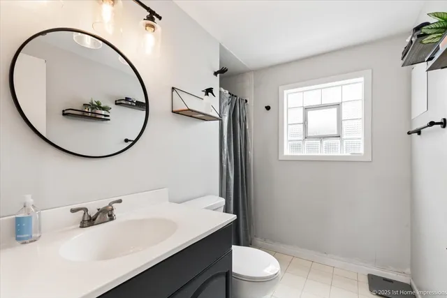 a bathroom with a sink a toilet and a mirror