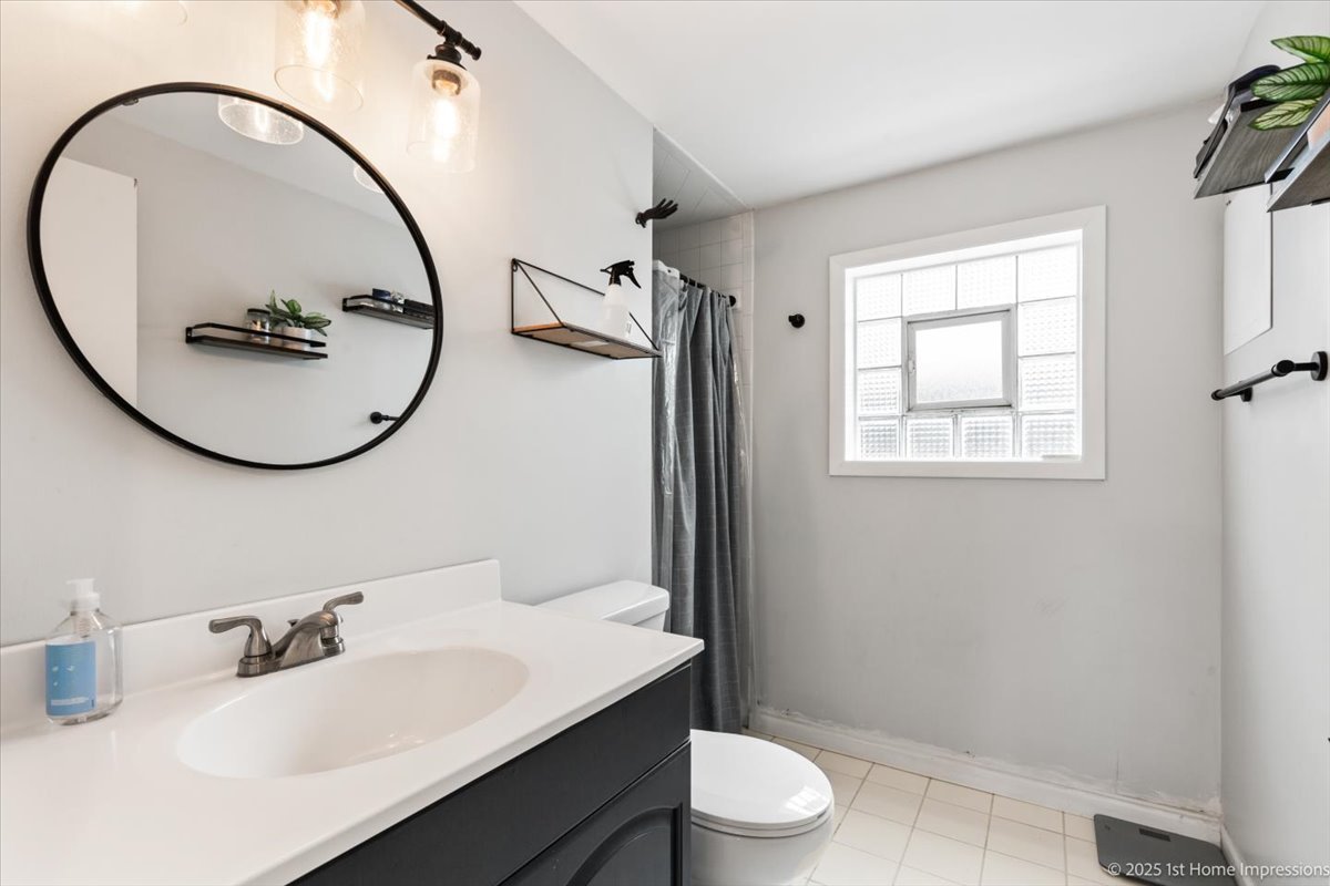 15309 Walnut Road Oak Forest, IL 60452 - Photo 15 of 23 a bathroom with a sink a toilet and a mirror