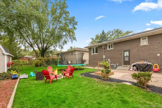 a front view of a house with garden and sitting area