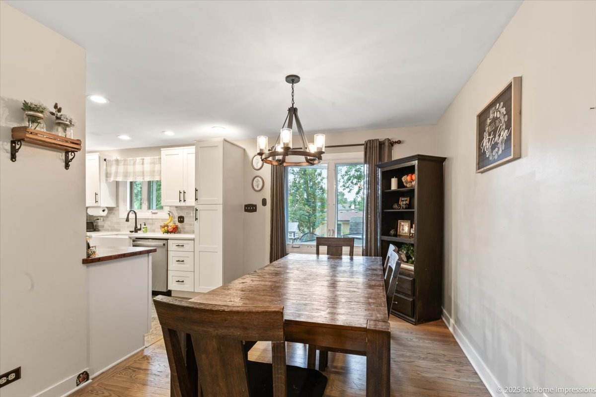 15309 Walnut Road Oak Forest, IL 60452 - Photo 5 of 23 a dining room with stainless steel appliances kitchen island a table and chairs