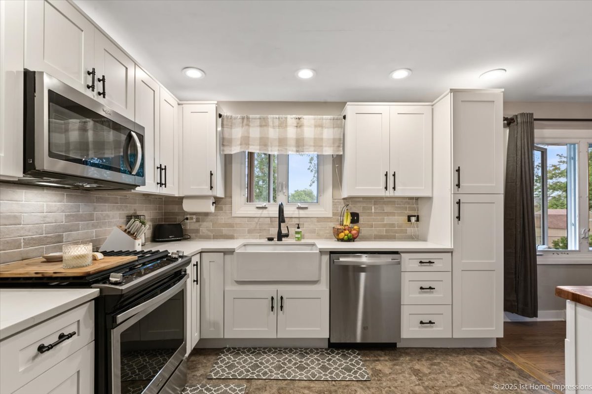 15309 Walnut Road Oak Forest, IL 60452 - Photo 6 of 23 a kitchen with a sink stove oven and cabinets