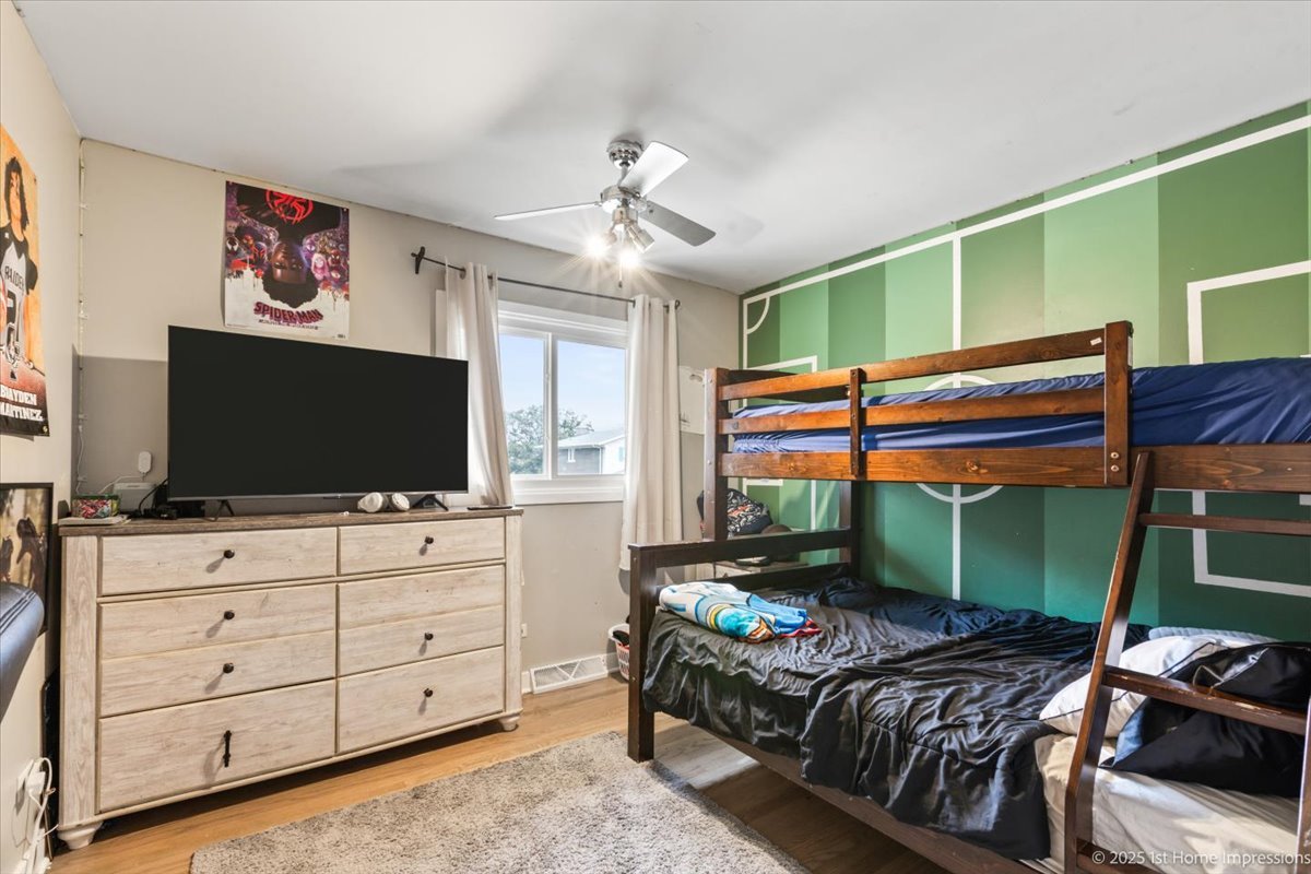 15309 Walnut Road Oak Forest, IL 60452 - Photo 9 of 23 a bedroom with a bed and a flat screen tv