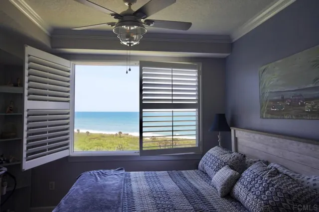 a bedroom with a bed and a computer on the desk