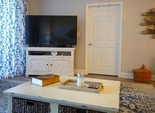 a living room with furniture and a wooden floor