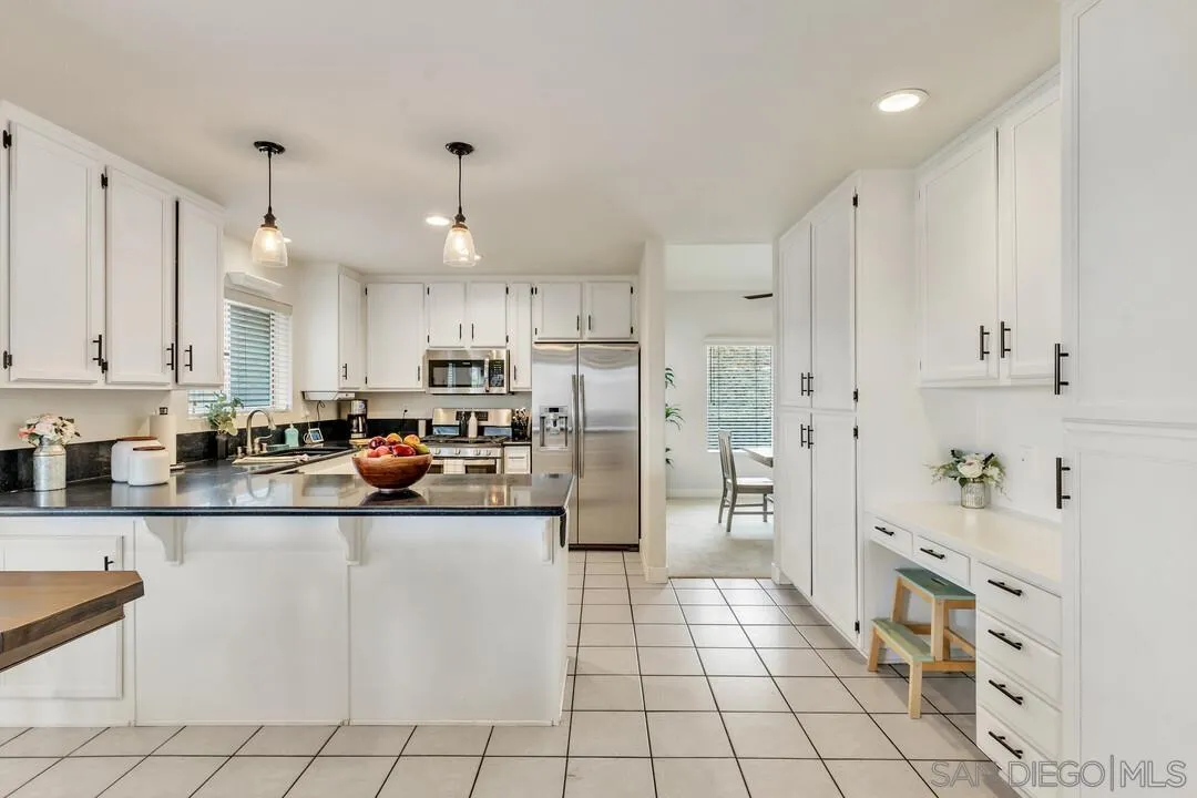 9410 Brian Way El Cajon, CA 92021 - Photo 25 of 49 a kitchen with stainless steel appliances a refrigerator sink and cabinets
