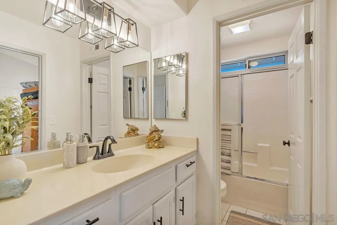 9410 Brian Way El Cajon, CA 92021 - Photo 40 of 49 a bathroom with a sink vanity granite and a mirror