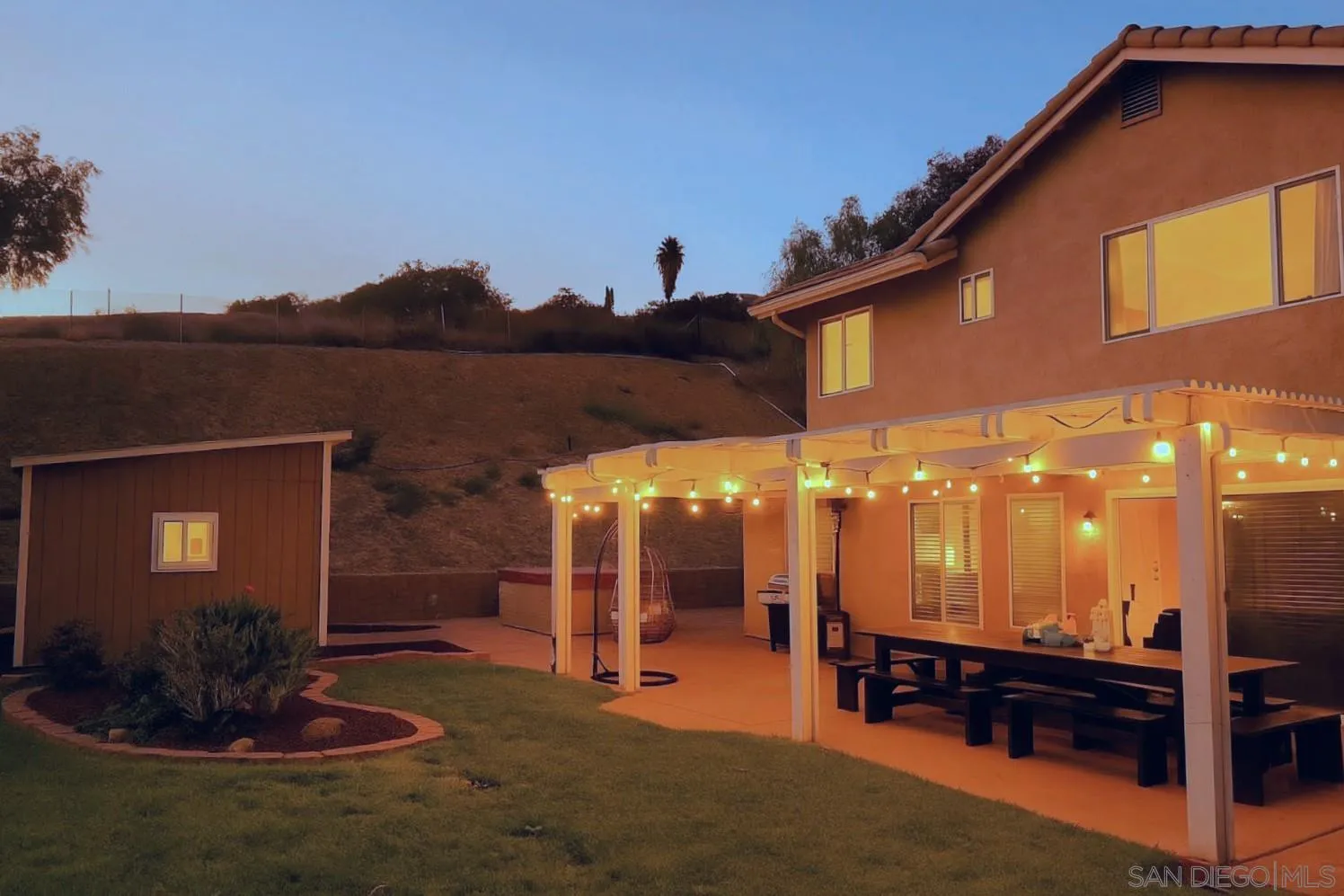 9410 Brian Way El Cajon, CA 92021 - Photo 4 of 49 a backyard of a house with table and chairs