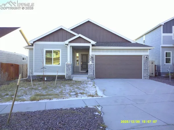 a view of a house with a yard and garage