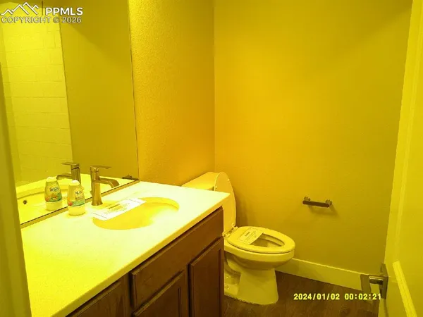 a bathroom with a sink mirror and toilet