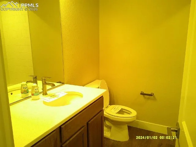 a bathroom with a sink mirror and toilet