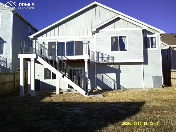 a view of house with wooden stairs