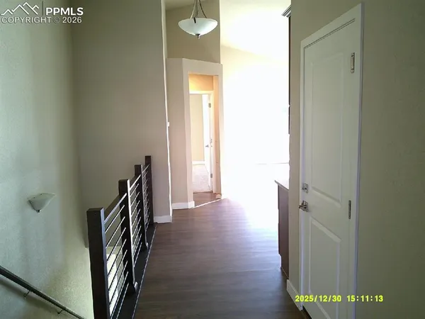 a view of a hallway with wooden floor