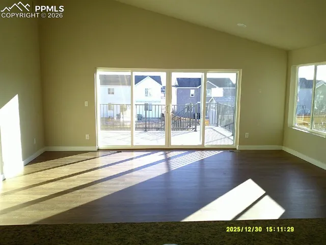 a view of an entryway with wooden floor