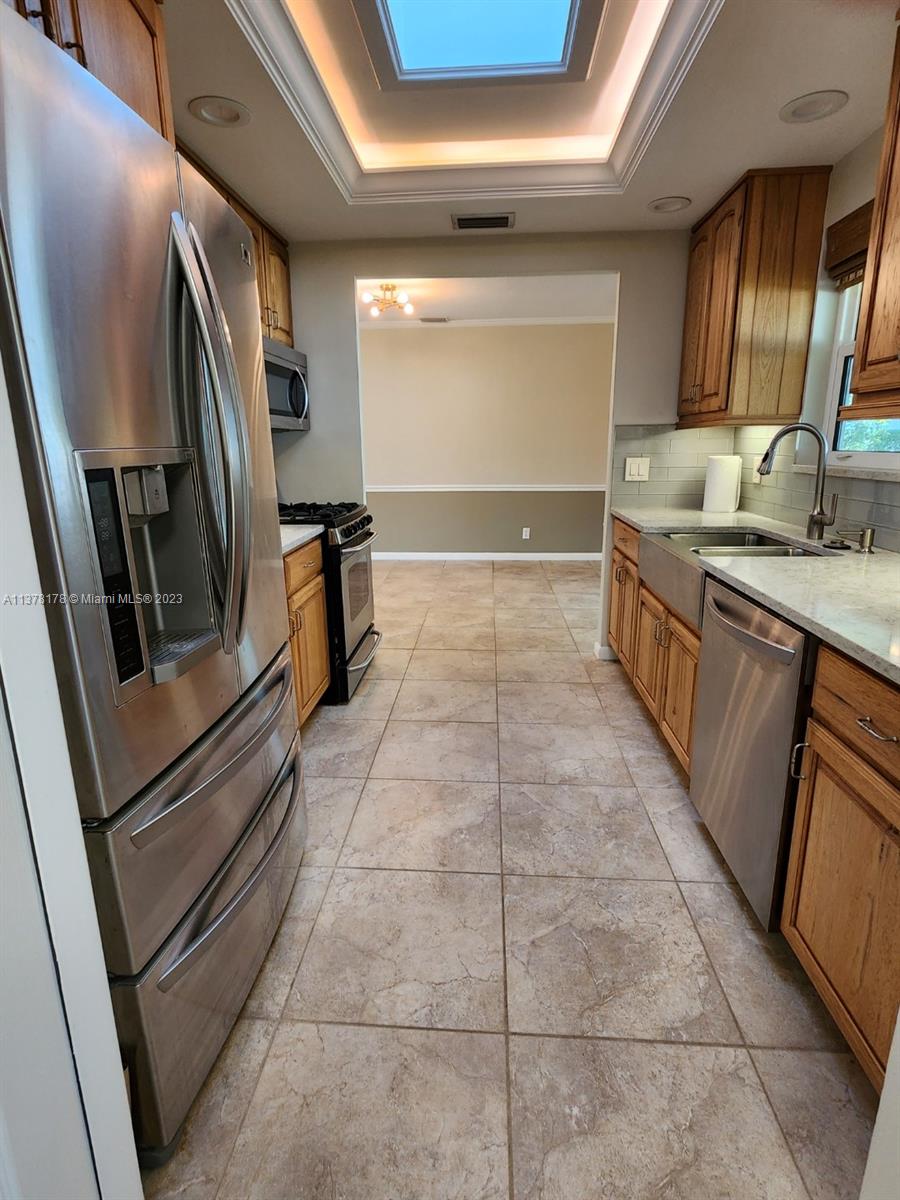 1513 Lance Road Jupiter, FL 33469 - Photo 11 of 33 a kitchen with stainless steel appliances granite countertop a refrigerator and a stove